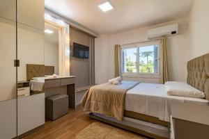 En eller flere senge i et værelse på Rosa Casa Geminada Villa Mariana