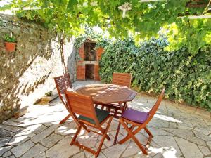 a wooden table and chairs sitting on a patio at Apartment Kameo with terrace in Dubrovnik