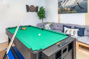 a living room with a pool table and a couch at Laurel Reef in Tybee Island