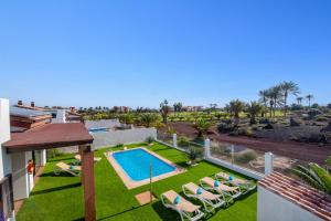 an image of a backyard with a swimming pool at Villa Fakay by Villa Plus in Caleta De Fuste