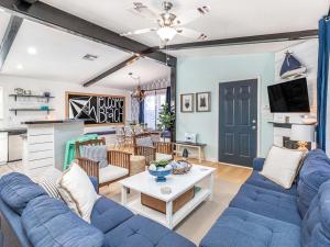 a living room with a blue couch and a table at Laurel Reef in Tybee Island