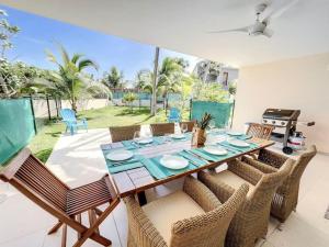 a dining room with a table and chairs at Villa Carpe Diem sea front pool Orient Bay in Orient Bay