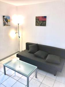 ein Wohnzimmer mit einem Sofa und einem Tisch in der Unterkunft Studio Apartment near to Paris in Créteil