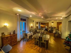 een eetkamer met tafels en stoelen en een kerstboom bij Logis Hotel Restaurant la Corniche des Cevennes in Saint-Jean-du-Gard