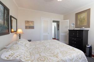 a bedroom with a bed and a dresser in it at The Traveler Suite C1 in Hartford