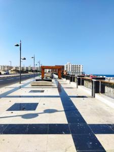 a walkway on a bridge with buildings in the background at apartment with separate entrance near Arabia hotel in Hurghada