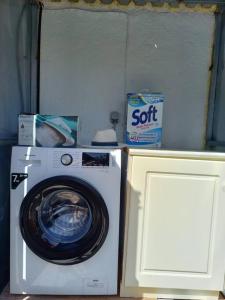 a washing machine sitting next to a box of soft at Agios Leon Apartment 2 in Agios Leon