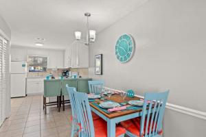 a kitchen and dining room with a table and chairs at Beach Haven - Seasonal Hot Tub, Fire Pit, BBQ, 700 Feet to Beach, Central PCB, FREE Daily Activities, & More! in Panama City Beach
