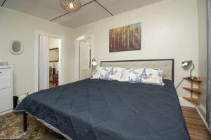 a bedroom with a large bed with blue sheets at The Bushnell Suite C2 in Hartford