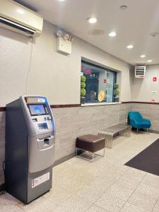 a atm machine in a waiting room with a window at Cabana Hotel Yankee Stadium in Bronx