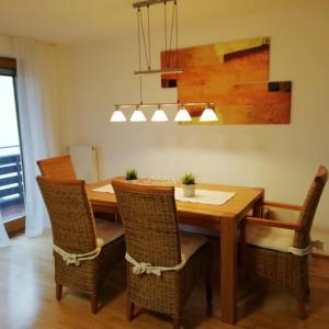 a dining room with a wooden table and chairs at Im Idyll 3 in Hengersberg