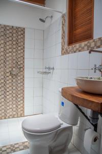 a bathroom with a toilet and a sink at CASA DE LOLA in Medellín