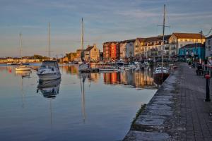 a group of boats are docked in a harbor at Two bedroom townhouse in the heart of Dungarvan in Dungarvan
