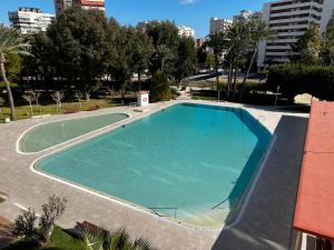 a large swimming pool in the middle of a building at BEACH & URBAN PLAYA SAN JUAN in Alicante