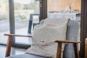 a pillow sitting on a chair in a room at Viktoria Guesthouse in Westerlo