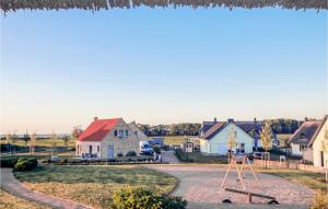 a house with a playground in the middle of a street at Nice Home In Zierow Ot Poeler Drift in Zierow +24 photos