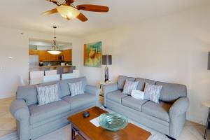 a living room with two couches and a table at TOPS'L Summit I in Destin