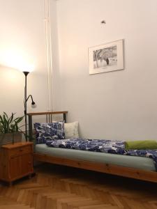 a bed in a room with a picture on the wall at Gaia Hostel in Budapest