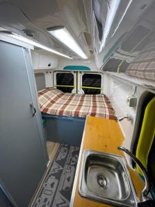 an inside view of a tiny house with a sink at Autocaravana in Puerto de Sagunto