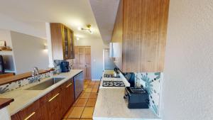 a kitchen with a sink and a stove top oven at Steel Bender Retreat #3293 in Moab