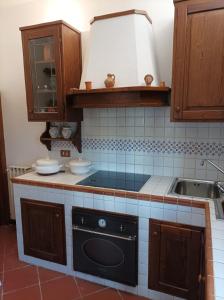 a kitchen with a stove and a sink at Villa Camelia Tuscany in Pescia