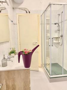 uma casa de banho com um grande vaso com flores em Roma IceCream Apartment em Roma