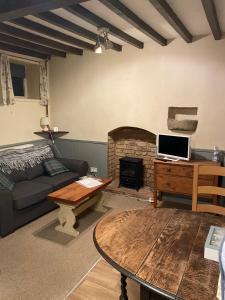 a living room with a couch and a fireplace at The Barn at Providence Cottage in Alkborough