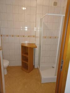 a small bathroom with a shower and a toilet at Domimat-Lila in Dębki +24 photos