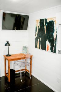 a desk with a lamp and a painting on a wall at The Middleton Hotel in Graham