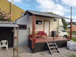 a tiny house with a deck and a ladder at Vacaciones2023 in Mar del Plata