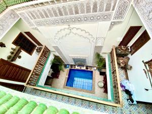 an overhead view of a building with a swimming pool at Riad Nouhal in Marrakesh