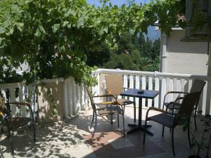 a patio with a table and chairs on a balcony at Mediteraneo Apartments in Budva