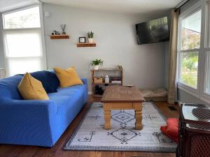 a living room with a blue couch and a coffee table at Bright 3bdrm perfect location 2.5 mi to SPAC , Close to track, downtown and Saratoga hospital in Ballston Spa