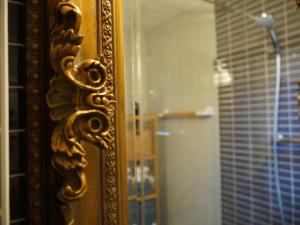 a mirror with a reflection of a shower in a bathroom at Cozy holiday home in a charming area in Montilla