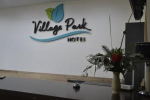 a sign for a village park hotel on top of a desk at VILLAGE PARK in Tandil