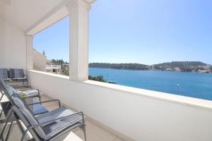 a balcony with chairs and a view of the water at Seaside Apartment M Zaton 5 - Sea View & Parking in Zaton