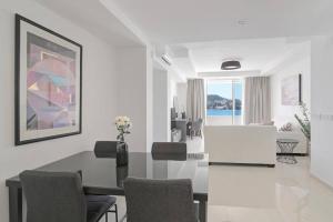 a white living room with a table and chairs at Seaside Apartment M Zaton 5 - Sea View & Parking in Zaton