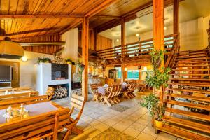 a large room with wooden ceilings and tables and chairs at Hotel Tenis in Chrząstowice