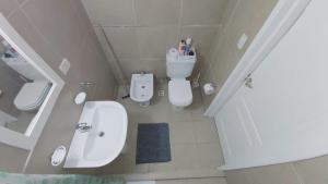 a small bathroom with a sink and a toilet at Abrazo Fueguino: calido comodo y centrico -WiFi in Ushuaia +12 photos