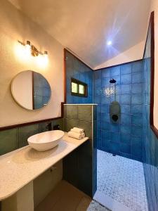 a bathroom with a sink and a shower at Rio Lindo Hotel in Dominical