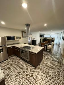 a kitchen with a stove top oven next to a living room at Suites Casa Mateo San Miguel Allende in San Miguel de Allende