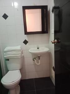 a bathroom with a toilet and a sink at V&B Apartamento in Bogotá
