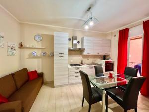 a living room with a couch and a glass table at Casa Riva Mare in Riva Ligure