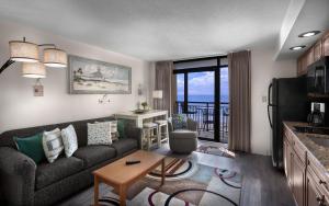 a living room with a couch and a table at Beach Cove Resort in Myrtle Beach
