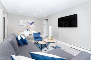 a living room with a couch and a table at Modern & Stylish 1-Bedroom Unit in Edmonton