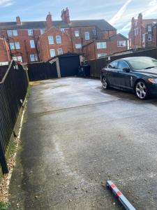 a car parked in a parking lot next to a fence at THE CHADWICK in Skegness