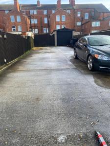 a car parked in a parking lot next to a building at THE CHADWICK in Skegness