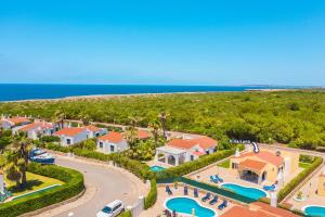 an aerial view of a resort with a pool at Villa Luna by Villa Plus in Cala'n Bosch