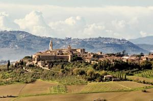 a village on top of a hill with a castle at PienzaLettings "Casa Olivieri" in Pienza