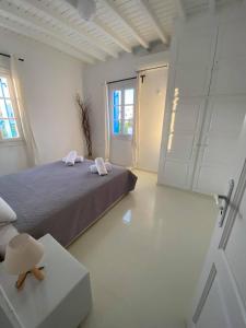 a bedroom with a bed with two towels on it at Fabrica Sunset Apartments in Megali Ammos